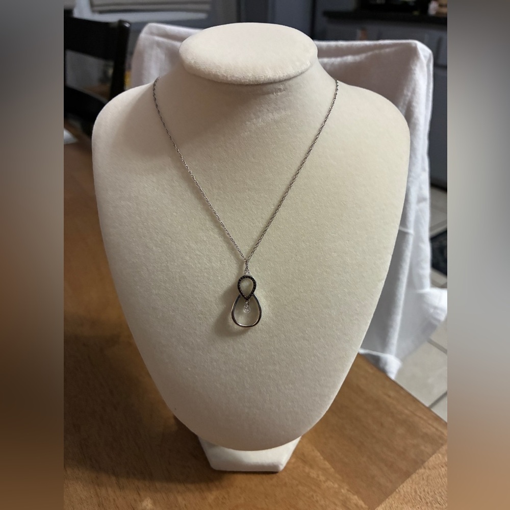 Teardrop-shaped pendant, similar to styles offered in palladium or silver tone